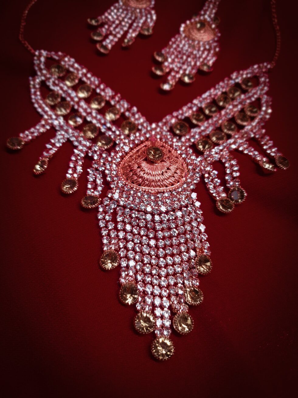 Rose gold plated necklace featuring intricate design, sparkling stones, and a delicate chain for elegant occasions.